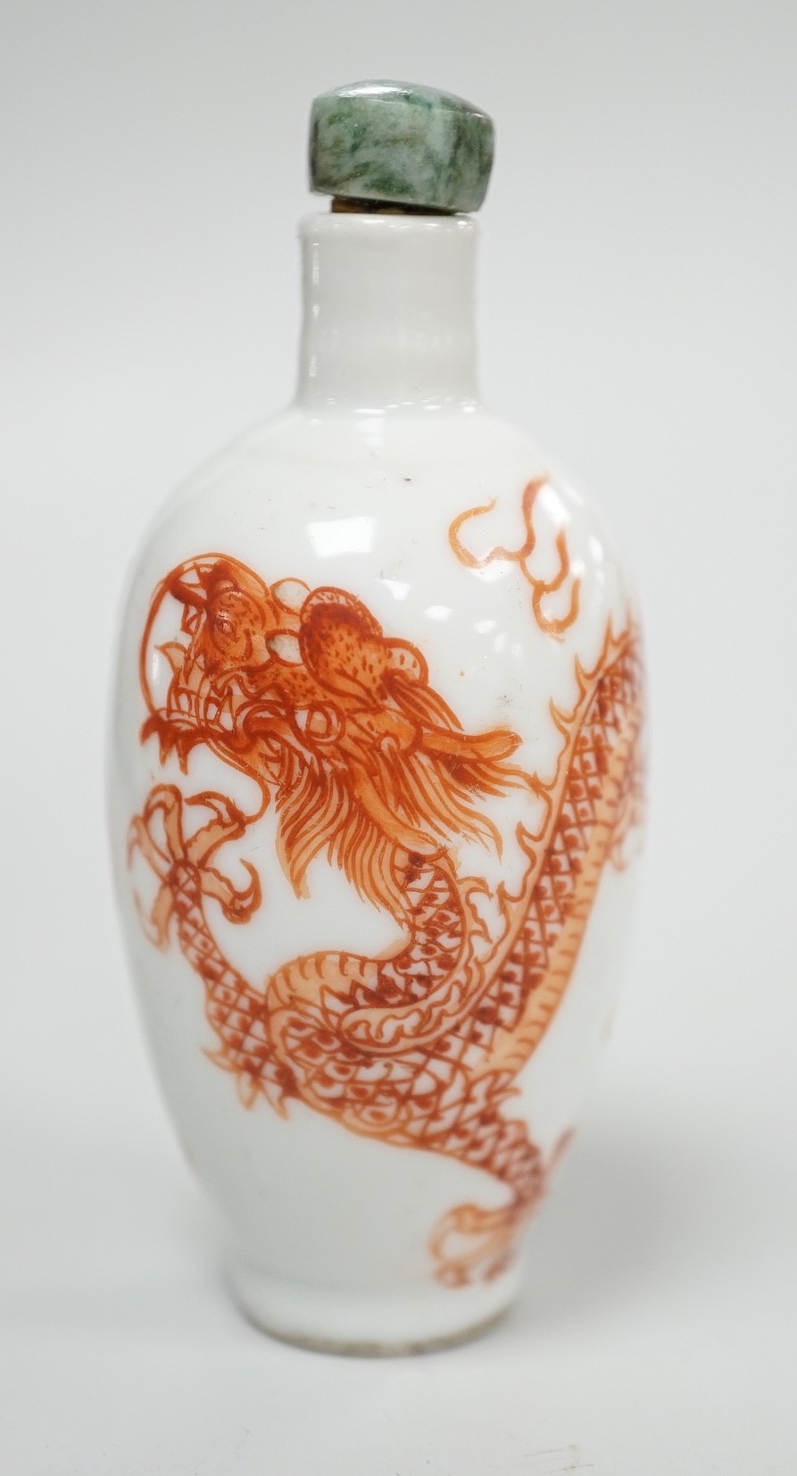 A Chinese rouge-de-fer 'dragon' snuff bottle, late 19th century, 6.7cm